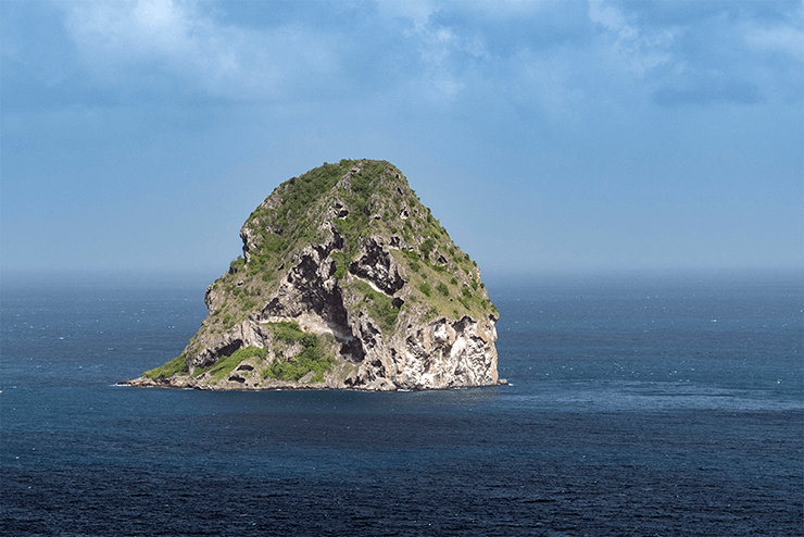 Below the surface, Diamond Rock presents a landscape of ledges and swim-throughs that are considered some of Martinique's premier dive sites.