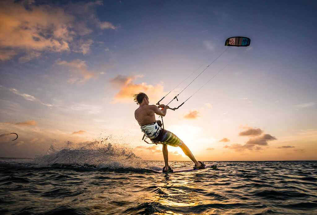 A kiteboarder makes a sunset run at Atlantis Beach, which is Bonaire's hub for kiting activity and lessons.