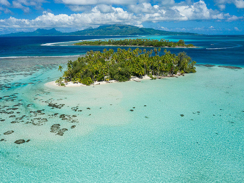 Small islands known as Motus line the edges of barrier reefs in the islands and atolls of Tahiti.