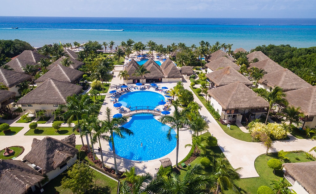 The two-story guest houses of the Allegro Resort cluster around resort pools, and are adjacent to Cozumel's San Francisco Beach.