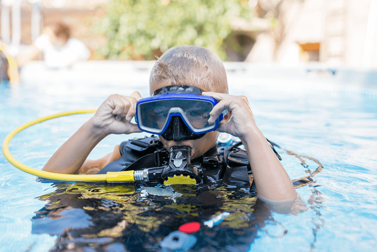 Young boy getting ready for a scuba diving adventure