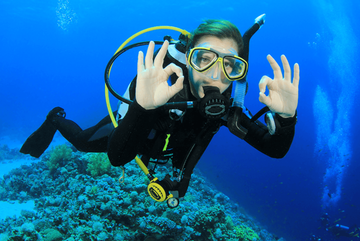 Young woman giving the Scuba Diver OK Sign